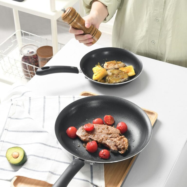 person holding black frying pan with fried food