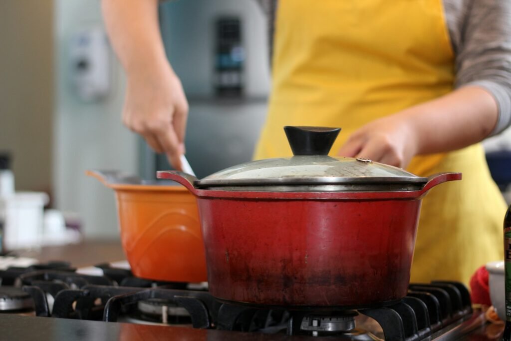 a woman in an apron is cooking on the stove